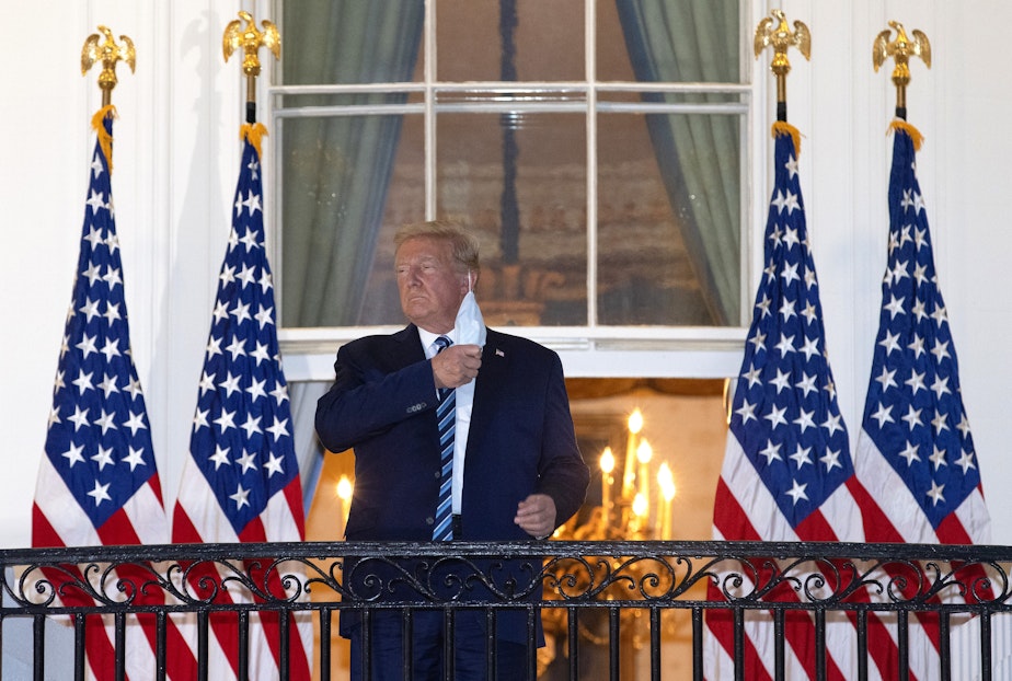 caption: President Trump removes his mask upon return to the White House from Walter Reed National Military Medical Center on Oct. 05, 2020 in Washington, DC. Trump spent three days hospitalized for coronavirus. (Win McNamee/Getty Images)