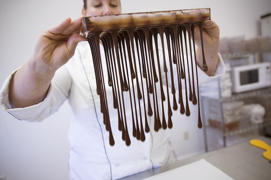 caption: Karen Neugebauer, artisan chocolatier and owner of Forte Chocolates, pours melted chocolate from a truffle mold at her company's production shop in Mount Vernon. Click on this photo to see more images.
