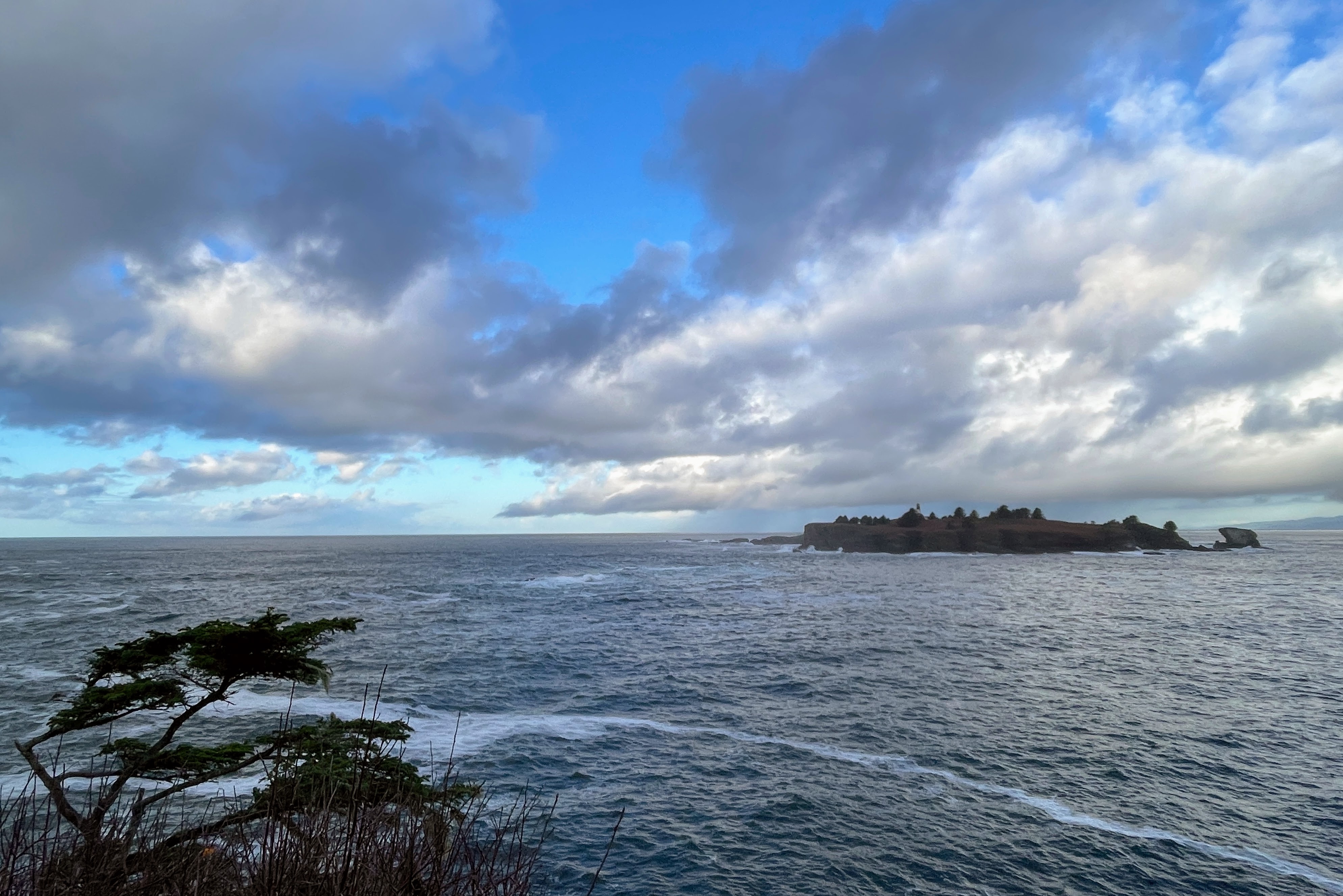 caption: Tatoosh Island and the North Pacific Ocean, seen from Washington's Cape Flattery on Nov. 13, 2023.