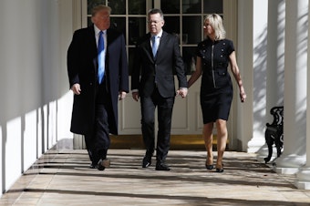 caption: Andrew Brunson walks down the colonnade of the White House on Saturday, flanked by his wife, Norine, and President Trump.