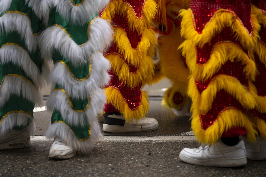 caption: Mak Fai Dragon and Lion dancers get ready to perform their first of several performances during the Lunar New Year celebration on Saturday, Feb. 4, 2023, in Seattle’s Chinatown-International District. 