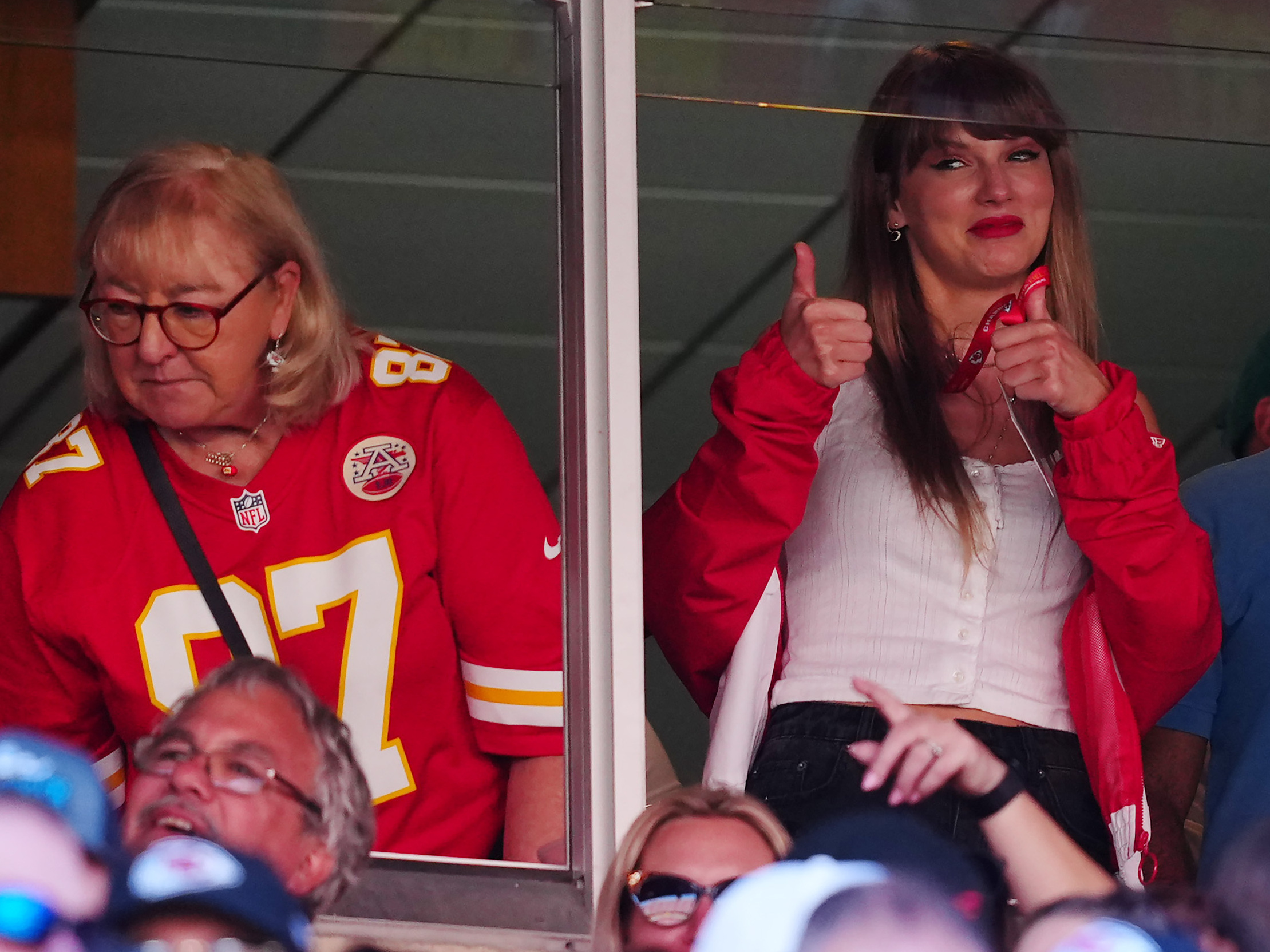 caption: Donna Kelce, wearing her son Travis' No. 87 jersey, and Taylor Swift are seen during the Kansas City Chiefs' game with the Chicago Bears in Kansas City, Missouri. Sales of Kelce's jersey soared after Swift appeared at the game.