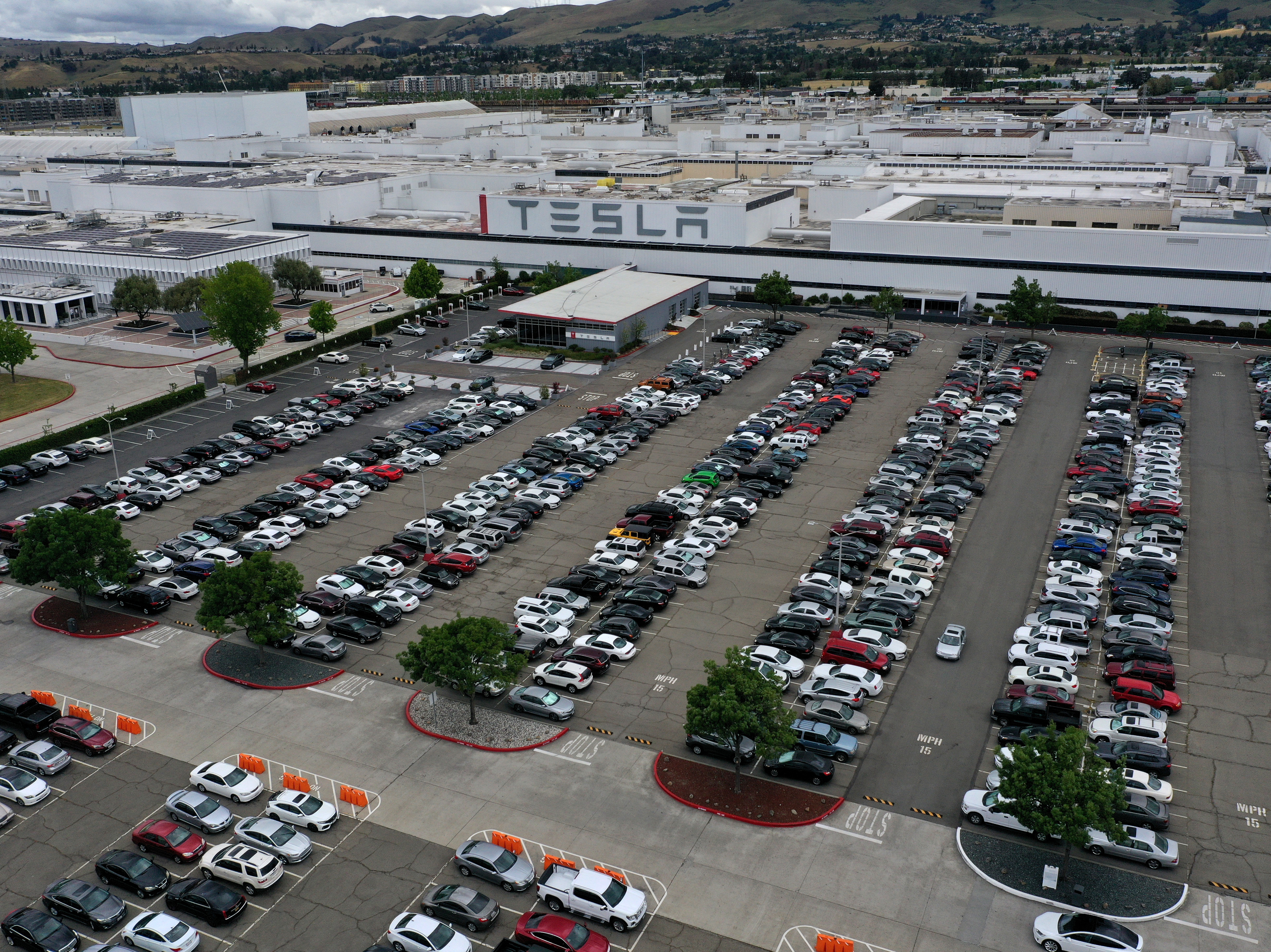caption: An aerial view of the Tesla factory in Fremont, Calif., in May. Gov. Gavin Newsom signed an executive order on Wednesday that bans the sale of new gasoline-powered vehicles in the state by 2035.