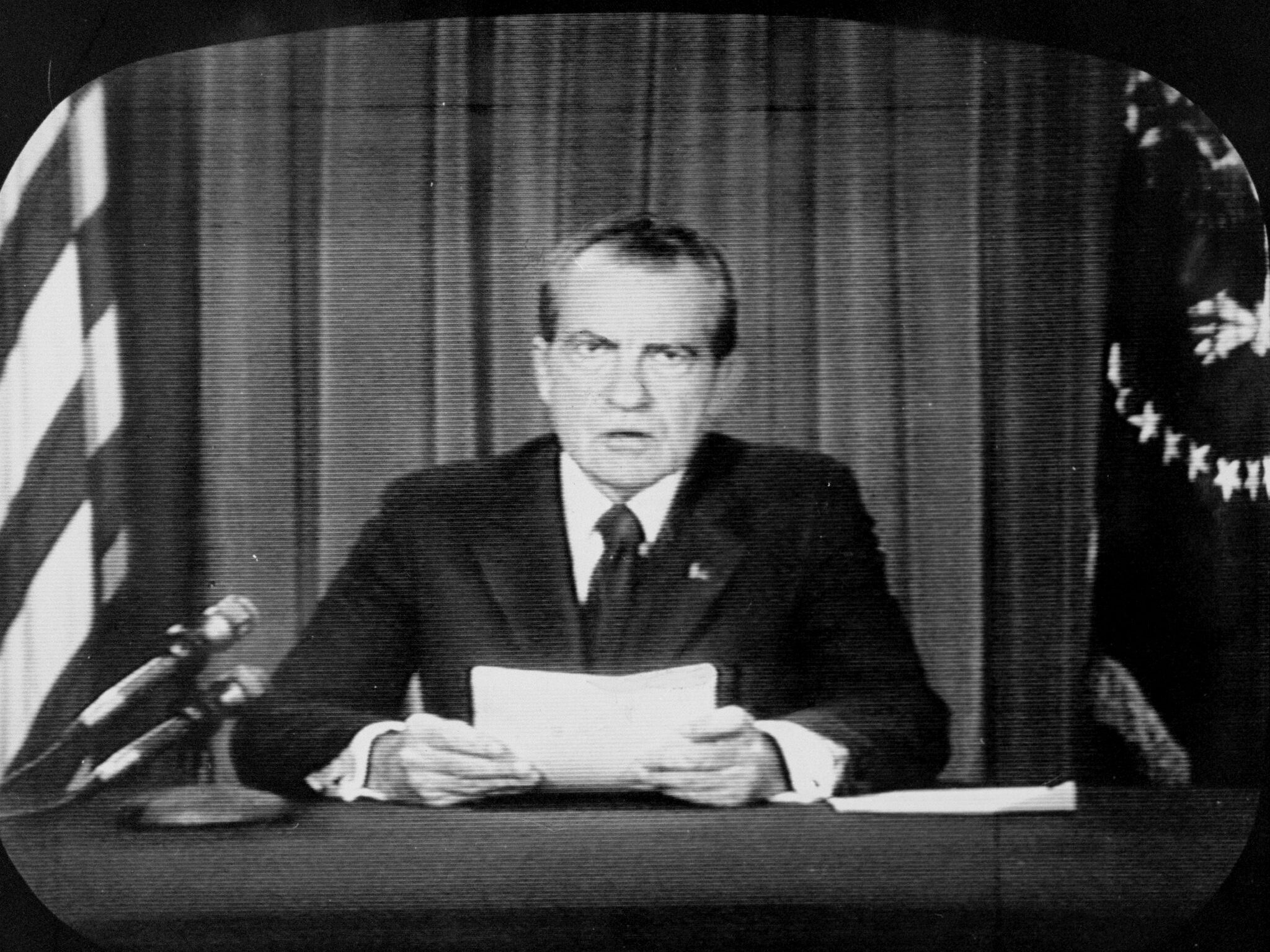 caption: TV image of President Richard Nixon announcing his decision to resign. 