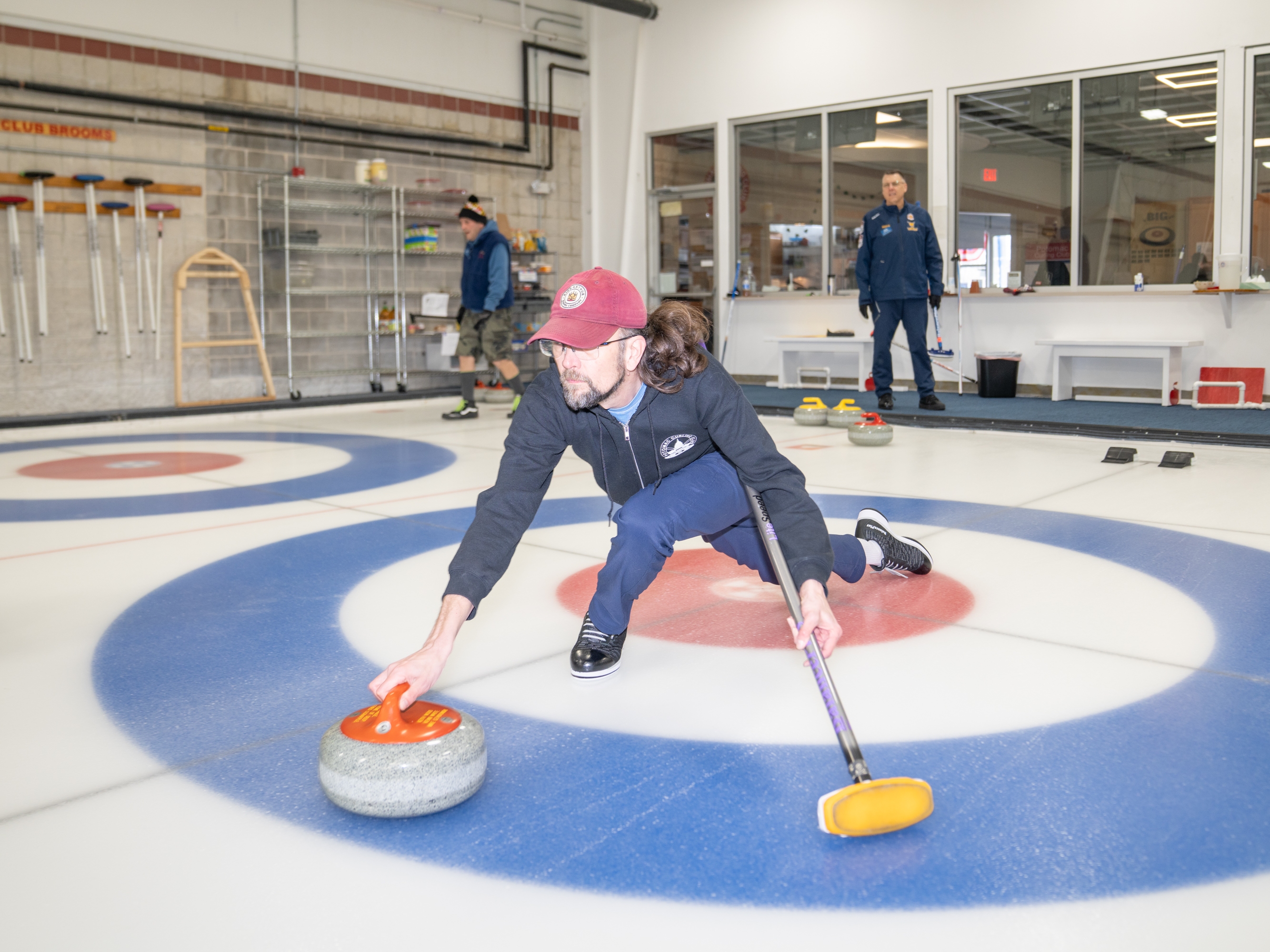 caption: Ted Hallock delivers a rock during a curling game at the Potomac Curling Club in Laurel, Md. Curling clubs often see a boost in interest following the Winter Olympics.