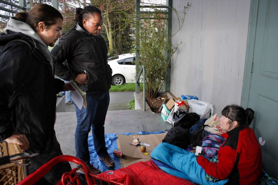 caption: Social workers Bradly Smith and Jackie St. Louis check in on Tonja Warner, who is homeless. Smith and St. Louis walk with cops on their beat and connect people they encounter with services.