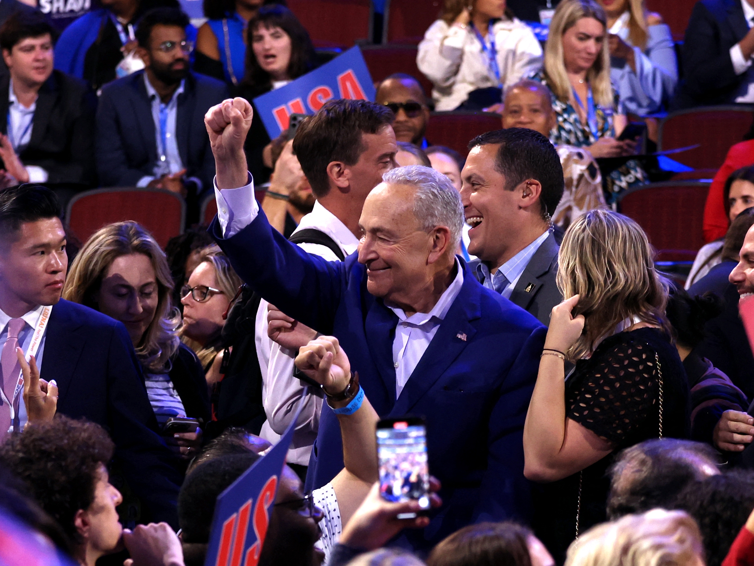 caption: Senate Majority Leader Chuck Schumer gestures on the first day of the Democratic National Convention in Chicago on Monday.