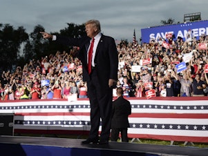 caption: Former President Donald Trump walks on stage during a rally at on July 3, 2021, in Sarasota, Fla. Trump has announced he is suing three of the country's biggest tech companies: Facebook, Twitter and Google.