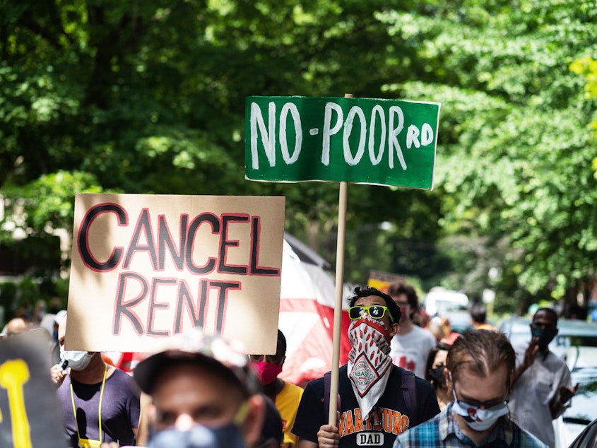 caption: The pandemic's financial pressures cause many Americans to struggle with rent. Demonstrators march in the Old Town neighborhood of Chicago this June to demand a lift on the Illinois rent control ban and a cancellation of rent and mortgage payments.
