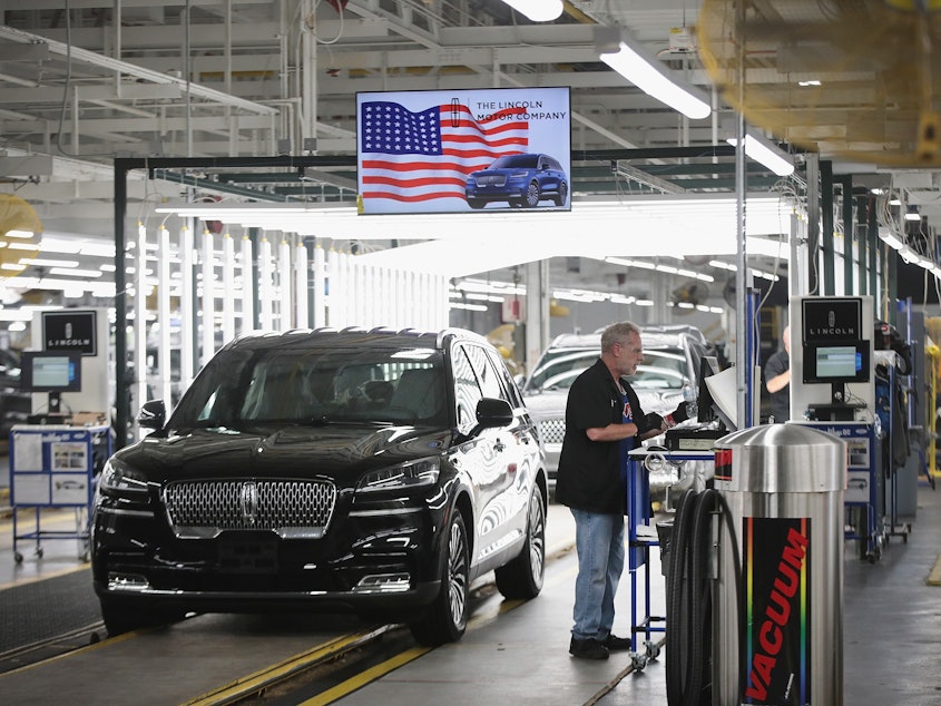 caption: A Lincoln Aviator rolls off the assembly line at a Ford assembly plant in Chicago. California agreed to a deal with four automakers, including Ford, to produce fuel-efficient cars.