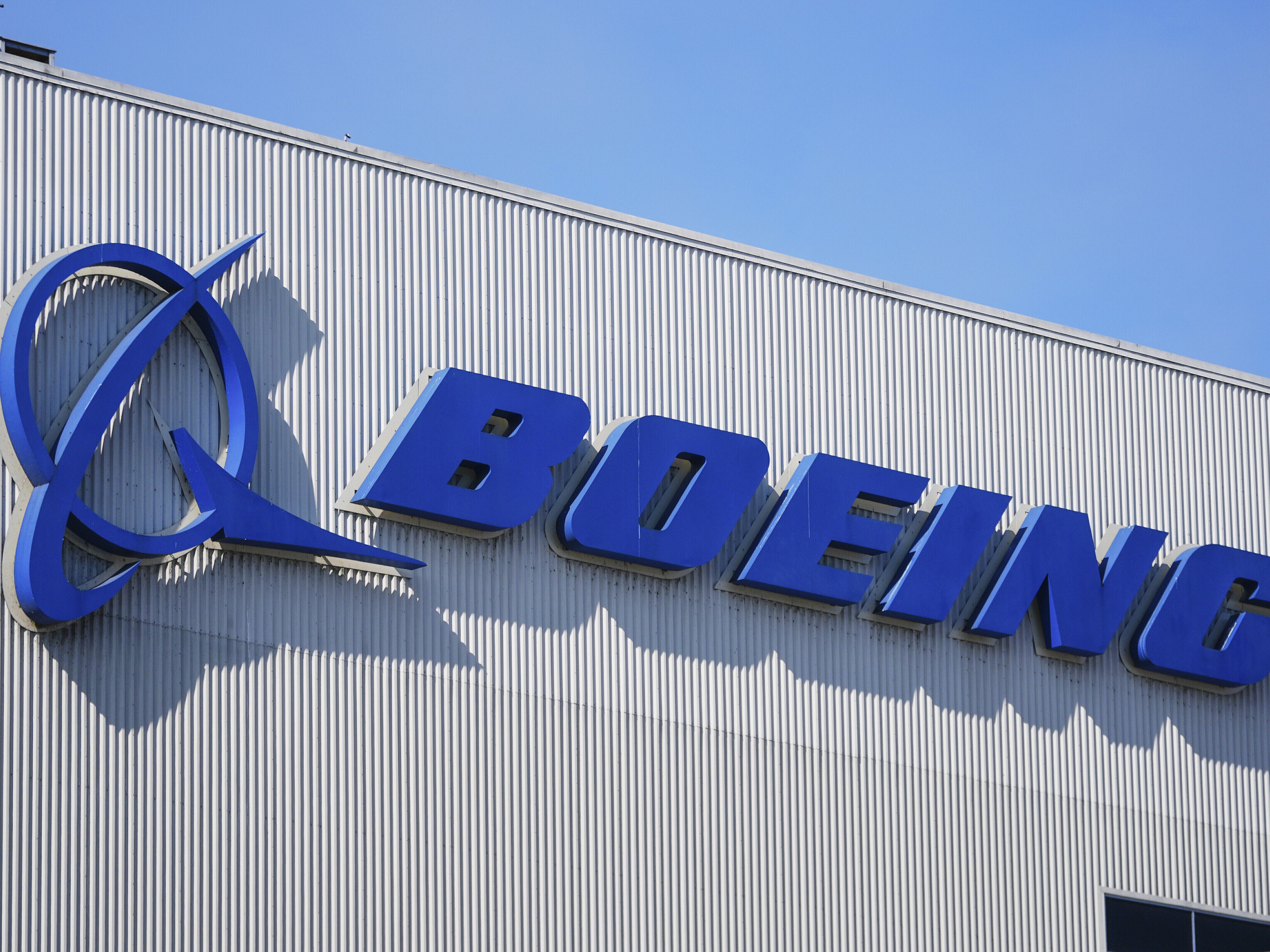 caption: The Boeing logo is displayed at the company's factory in Renton, Wash., on Sept. 24, 2024. The Federal Aviation Administration is seeking $3.1 million in fines from the aircraft maker over safety violations.