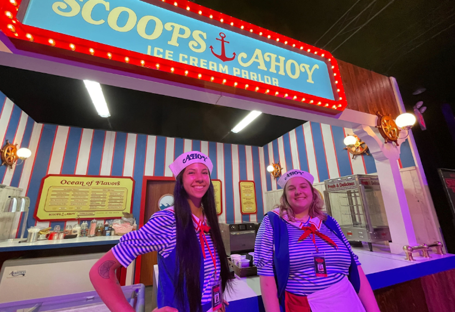 caption: Trinity Clark and Lauren Duncan travel to the 1980s to work at Scoops Ahoy at "Stranger Things: The Experience," live in Seattle over the summer of 2023. 