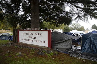 caption: Tents are shown outside of Riverton Park United Methodist Church where nearly 200 people are sheltering while seeking asylum, on Monday, Oct. 16, 2023, in Tukwila. 