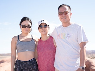 caption: Lindsey Cho (left), with her mother Judy Lee and father Wesley Cho after taking their turn at Delicate Arch.