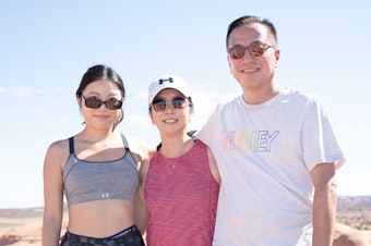 caption: Lindsey Cho (left), with her mother Judy Lee and father Wesley Cho after taking their turn at Delicate Arch.