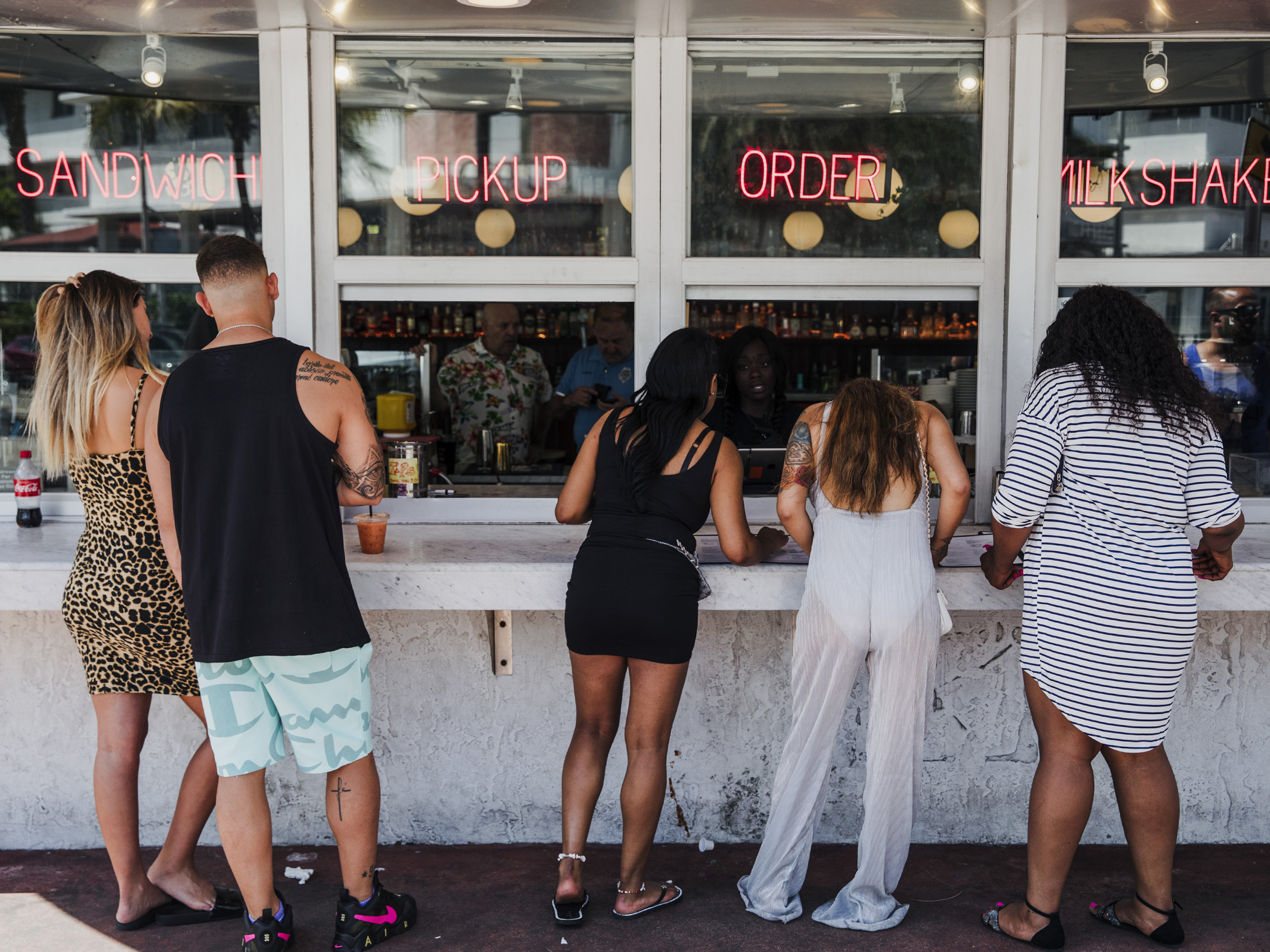 caption: Customers at this take-out window in Miami on March 20 were not practicing social distancing.