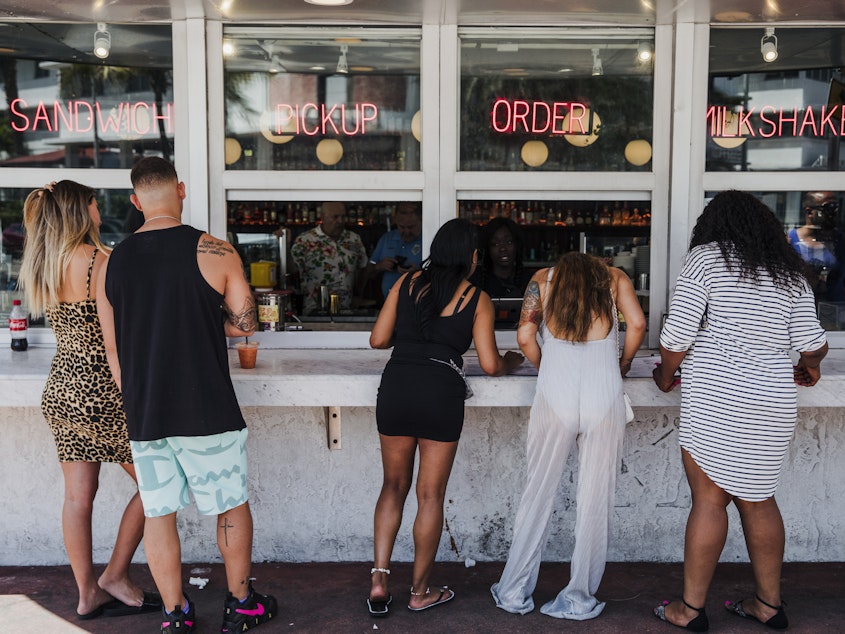 caption: Customers at this take-out window in Miami on March 20 were not practicing social distancing.