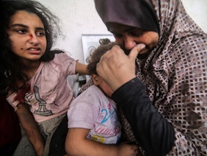 caption: People injured from Israeli air strikes on Oct. 12 wait outside a hospital to be treated. The sheer volume of medical need is overwhelming the small and exhausted number of staff at Gaza's medical facilities, says Dr. Mohammad Mattar, head of the radiology department at Al Shifa Hospital, the Gaza Strip's largest medical complex.