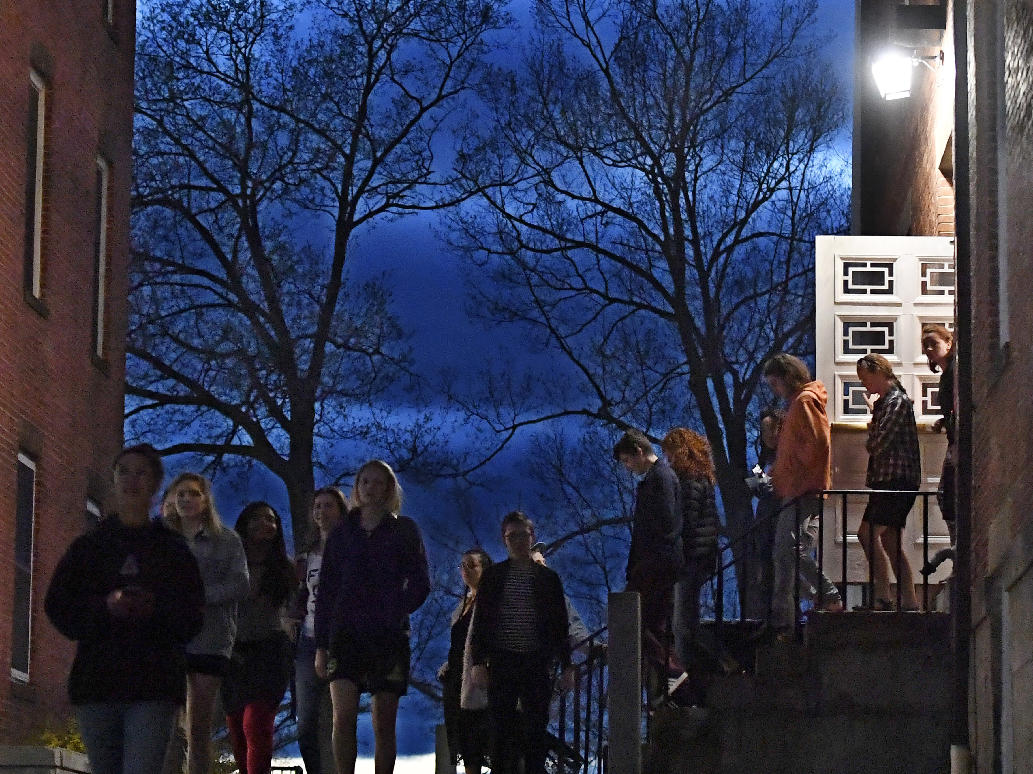 caption: Students walk out of Johnson Chapel at Amherst College in Amherst, Mass., April 24, 2019. Amherst College will no longer give admissions preference to the children of alumni, the school announced Wednesday.
