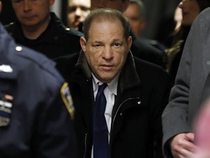 caption: Harvey Weinstein leaves court in New York City on Tuesday with the assistance of a walker. The former Hollywood megaproducer, whose career unraveled beneath scores of allegations, is facing multiple criminal charges of rape and predatory sexual assault.