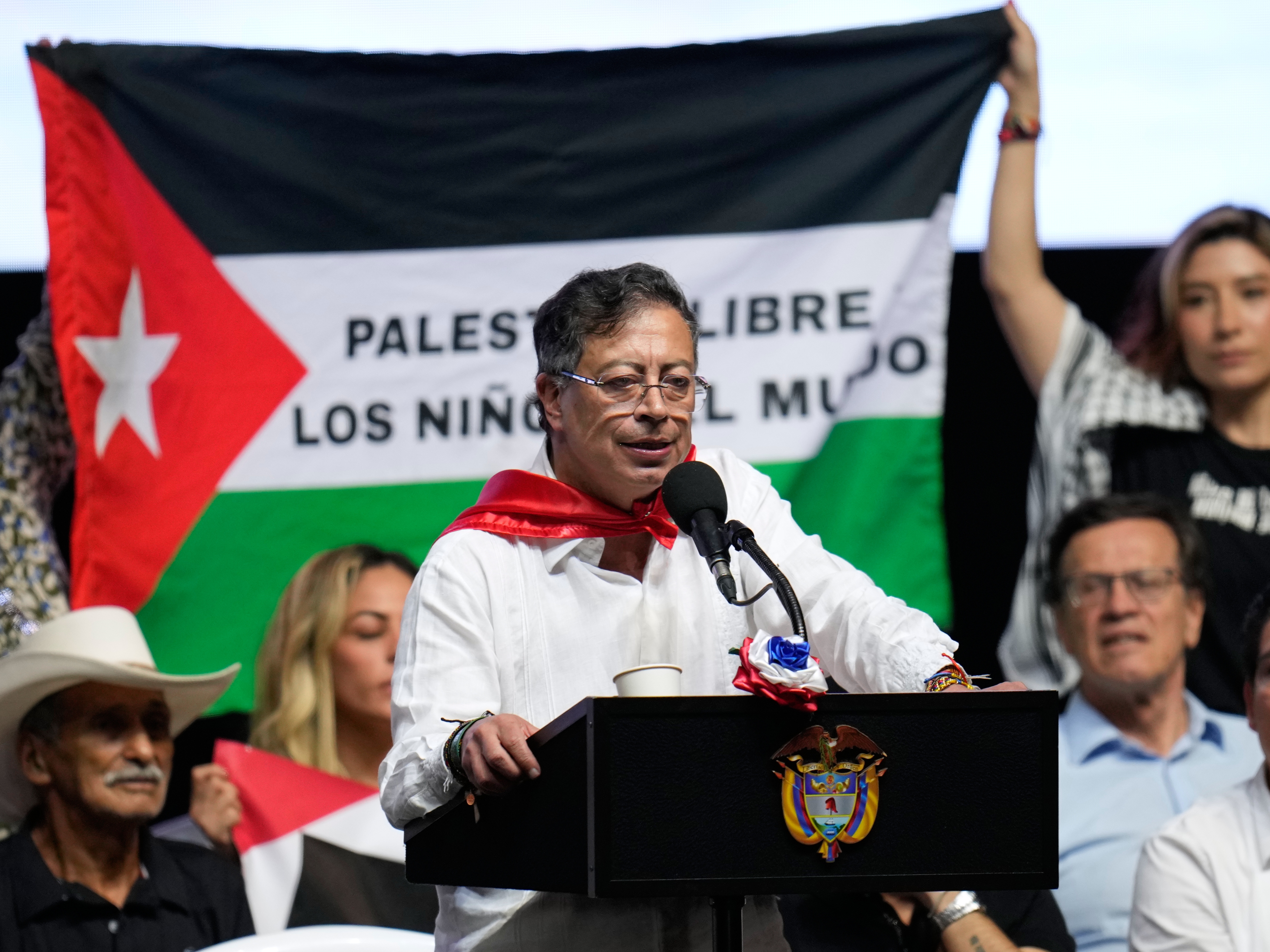 caption: Supporters of Colombian President Gustavo Petro display a Palestinian flag as he addresses a rally in Ibague, Colombia, Oct. 3, 2025.