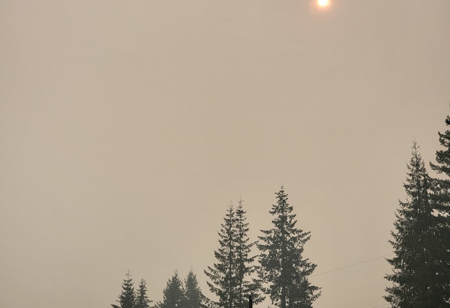 caption: A hazy sun pokes through a thick layer of wildfire smoke above Darrington, WA on Wednesday, October 19, 2022. 
