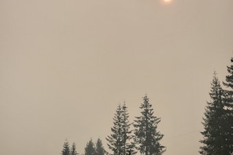 caption: A hazy sun pokes through a thick layer of wildfire smoke above Darrington, WA on Wednesday, October 19, 2022. 

