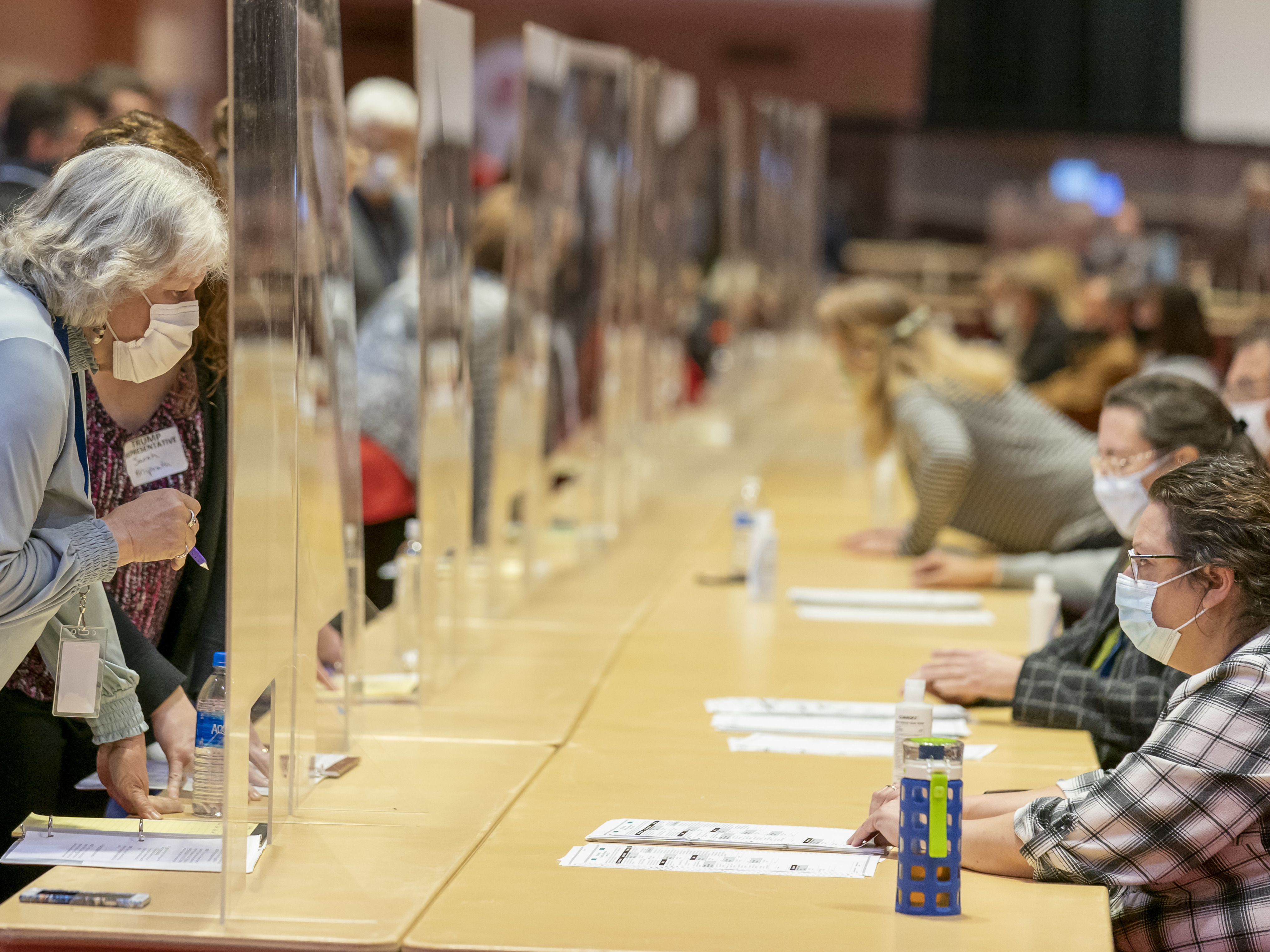 caption: Representatives for President Trump (left) review ballots Nov. 20 in Madison, Wis., during the recount vote in Dane County. A state judge on Friday rejected a Trump campaign attempt to challenge the voting process in Dane and Milwaukee counties.