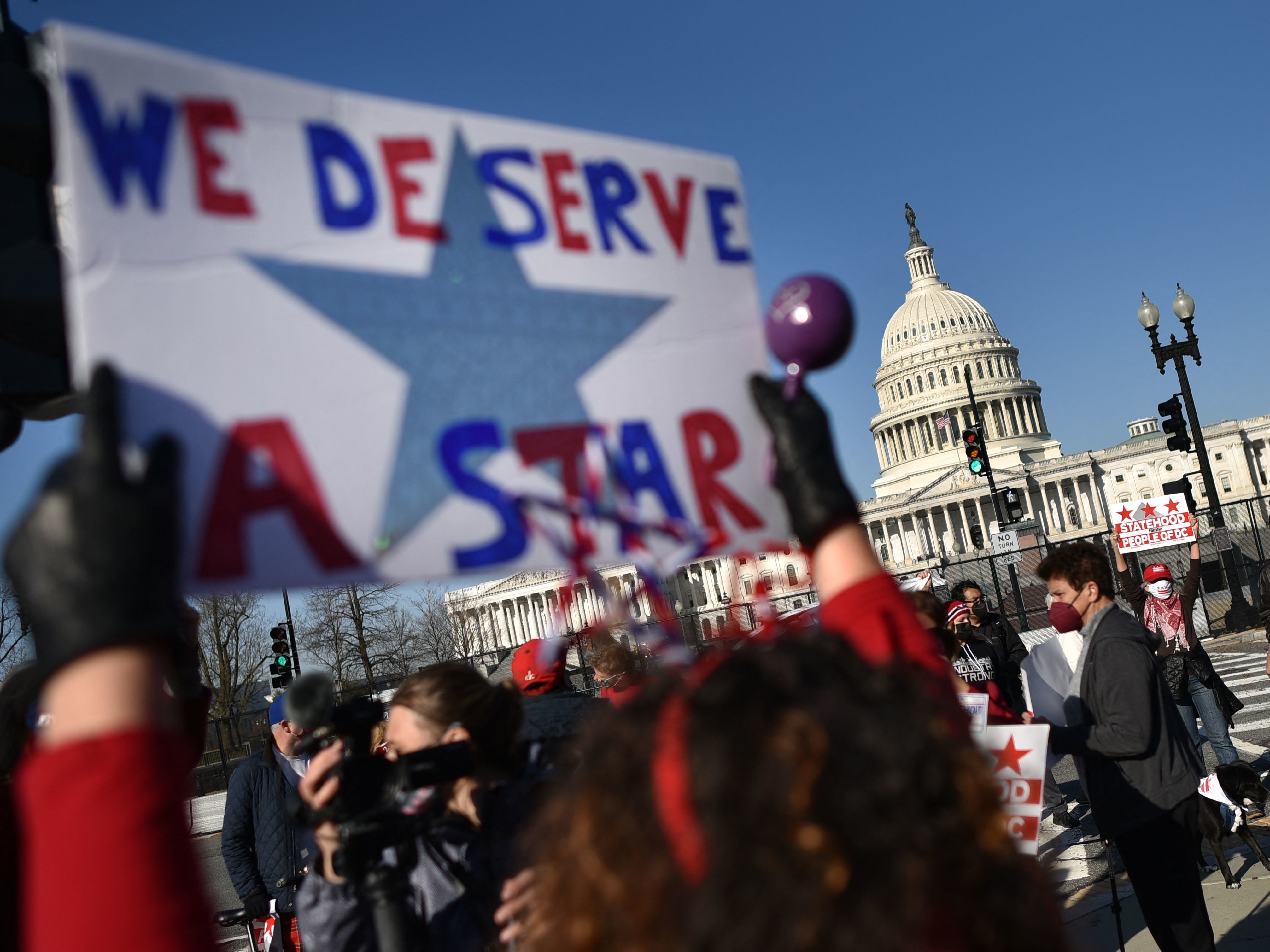 caption: Statehood activists took part in a rally in support of D.C. statehood near the US. Capitol in March. One month later, the House passed a bill that would make D.C. the nation's 51st state.