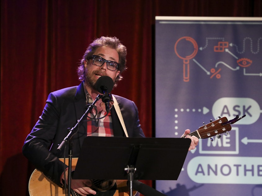 caption: <em>Ask Me Another</em>'s house musician Jonathan Coulton leads a music parody game at the Bell House in Brooklyn, New York.