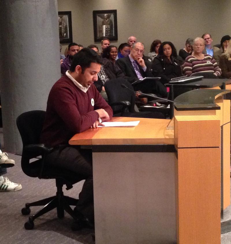 caption: Mohammad Kadhim, a baggage handler at Sea-Tac Airport, appeals to Port of Seattle Commissioners for higher wages.