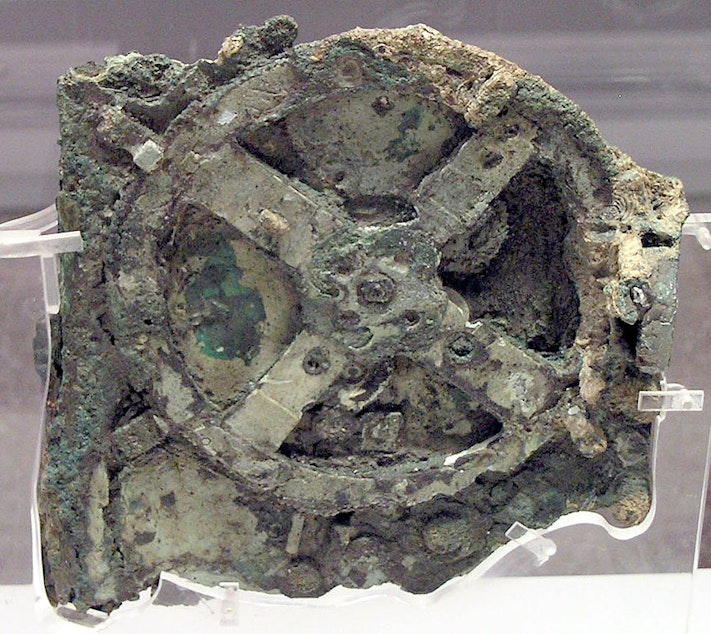 caption: A piece of the original Antikythera Mechanism. Divers found the first pieces off the coast of the Greek island Antikythera in 1901.  