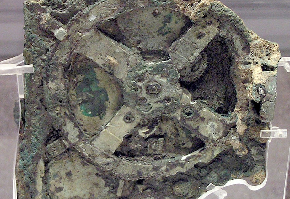 caption: A piece of the original Antikythera Mechanism. Divers found the first pieces off the coast of the Greek island Antikythera in 1901.  