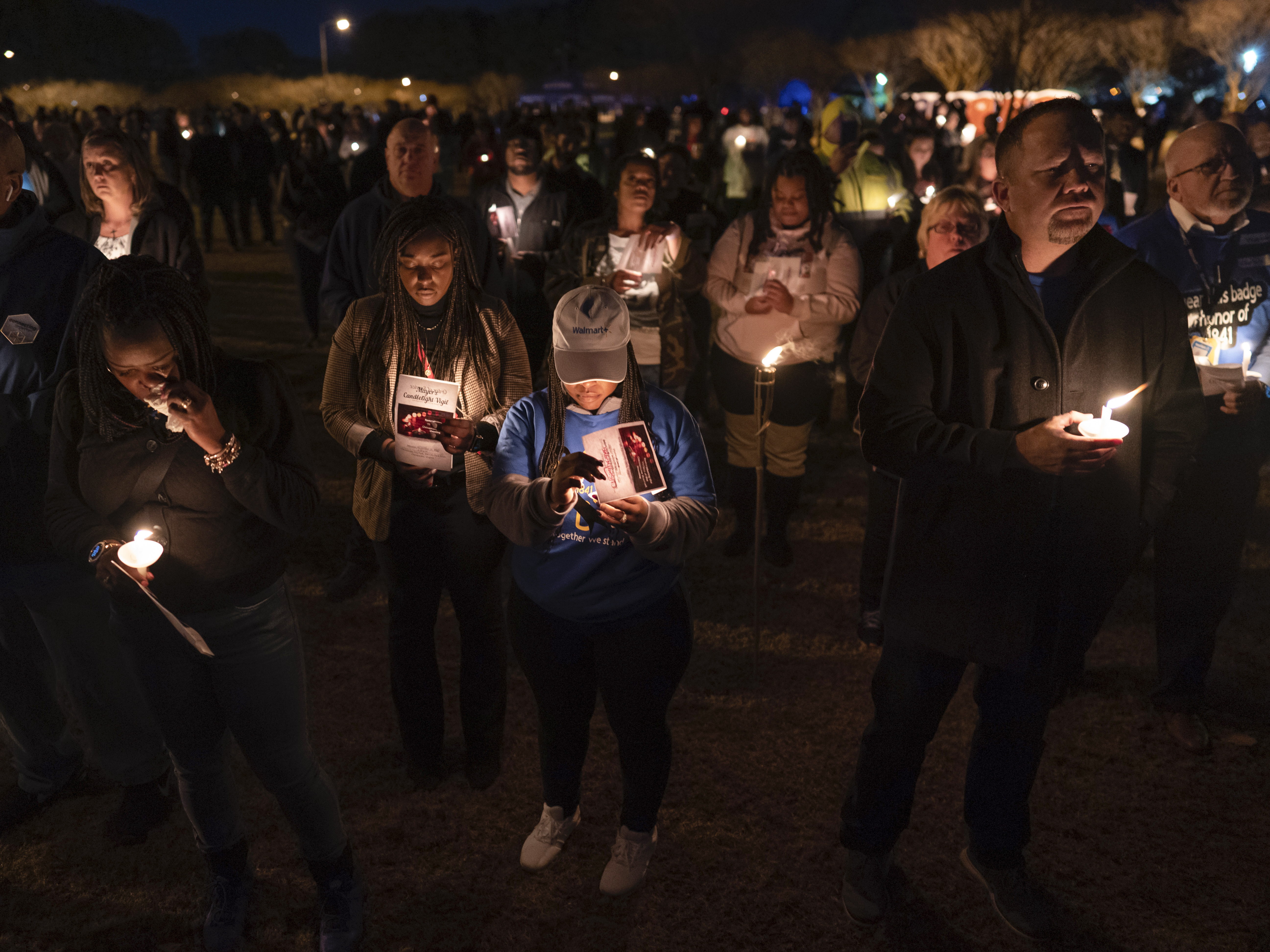 caption: Community members, including Walmart employees, gather for a candlelight vigil at Chesapeake City Park in Chesapeake, Va., on Monday for the six people killed at a Walmart in Chesapeake, Va.