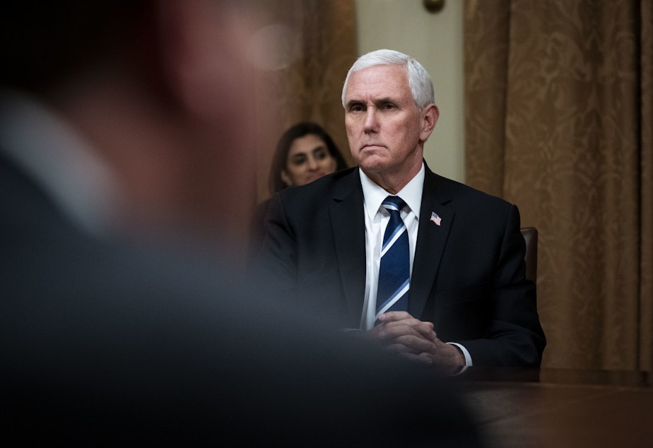 caption: WASHINGTON, DC - APRIL 27: U.S. Vice President Mike Pence listens during White House meeting with industry execs.