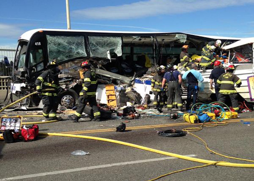 caption: A photo from the Seattle Fire Department's Twitter feed shows the side of a bus ripped open after a collision with a duck amphibious vehicle on the Aurora Bridge in Seattle.