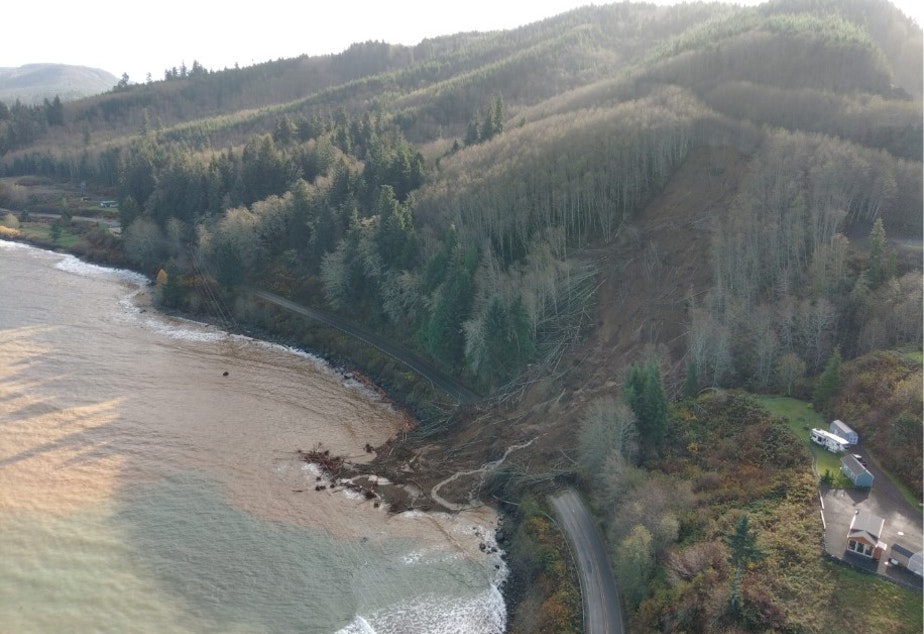 caption: A landslide near Sekiu, Washington, one of three blocking state Route 112 on Nov. 17, spills into the Strait of Juan de Fuca.