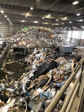 caption: A large mound of trash is shown at a Snohomish County transfer station