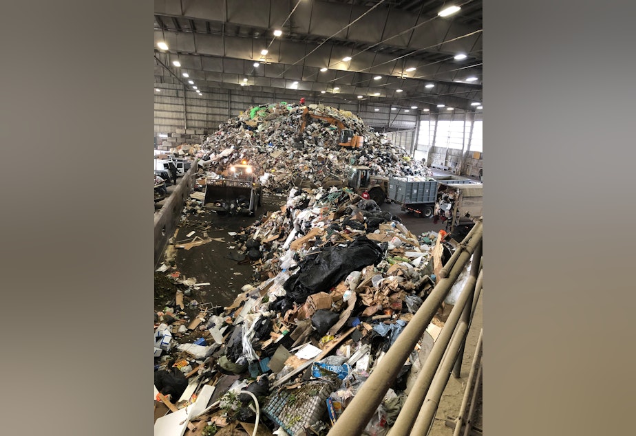 caption: A large mound of trash is shown at a Snohomish County transfer station