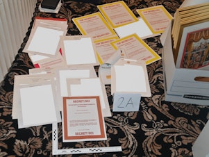 caption: This image contained in a court filing by the Department of Justice, and partially redacted by the source, shows documents seized during the Aug. 8 FBI search of former President Donald Trump's Mar-a-Lago estate.