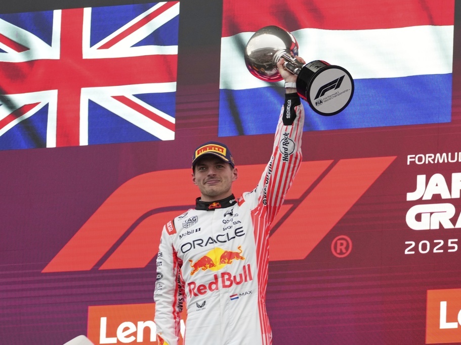 caption: F1 driver Max Verstappen of the Netherlands raises his trophy after the Japanese Formula One Grand Prix on April 6, 2025.