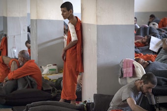 caption: Suspected Islamic State militants languish in a prison cell in northeastern Syria in October. The Pentagon has reported about 10,000 ISIS fighters are being held in prison facilities in northeastern Syria. Some 2,000 are said to be foreign fighters, with the rest identified as Iraqi and Syrian nationals. Of the 2,000 foreign fighters, an estimated 800 are from European nations.
