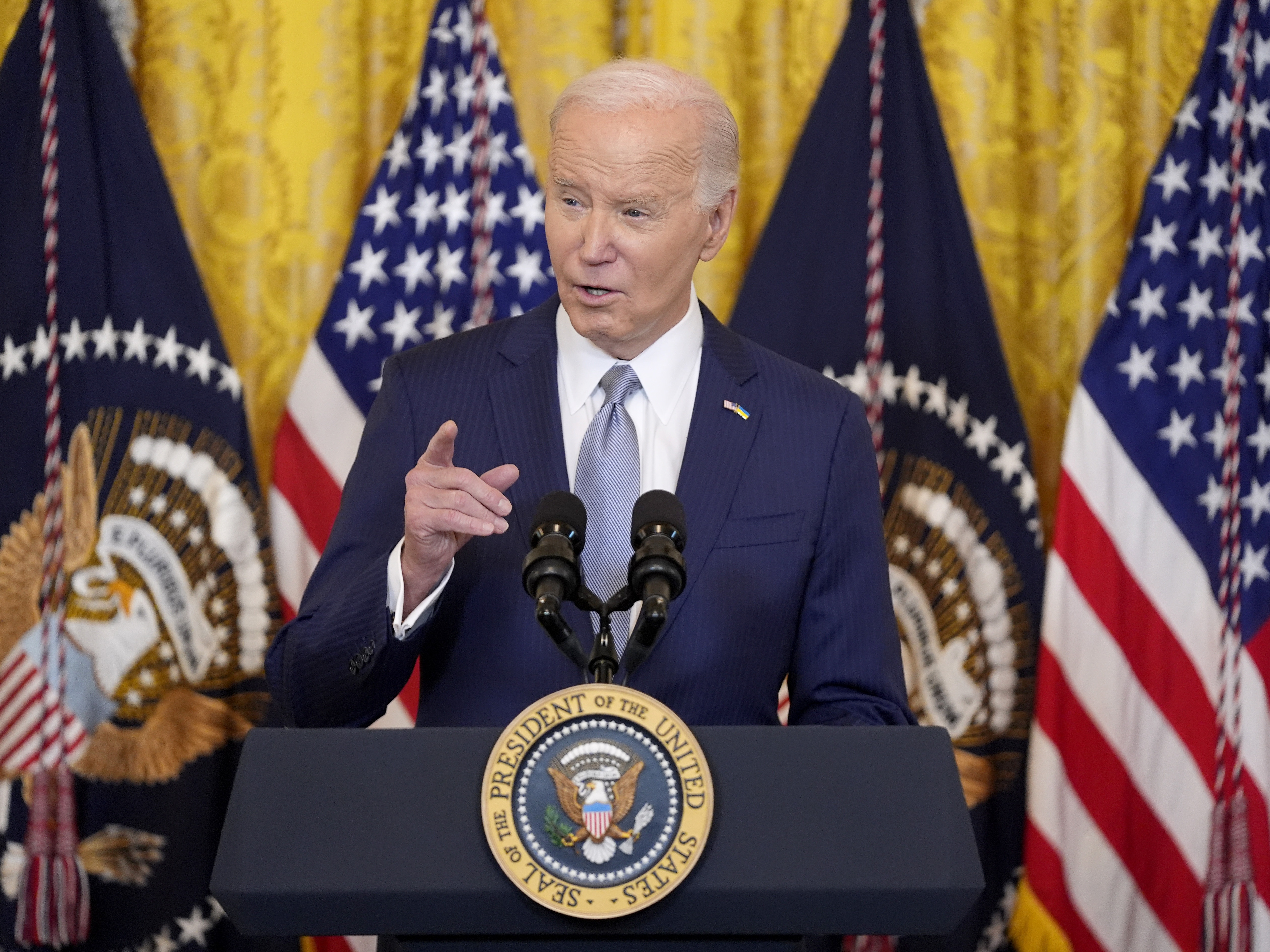 caption: President Joe Biden speaks during an event with the National Governors Association in the East Room of the White House in February.