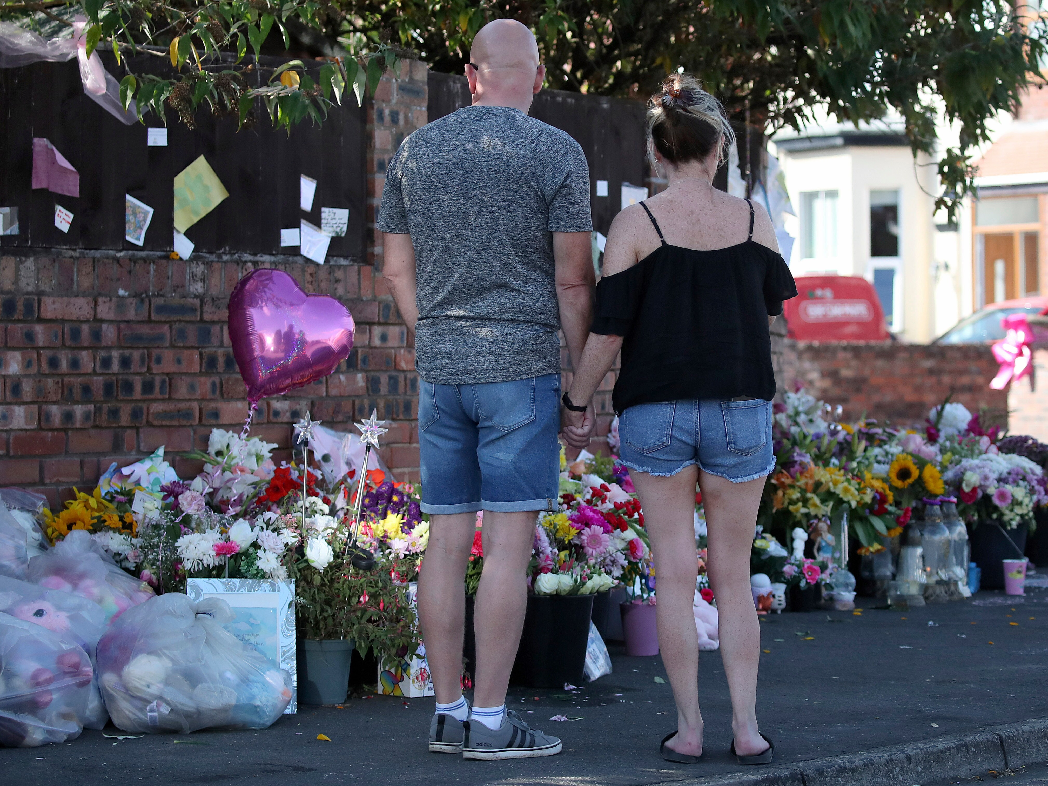 caption: FILE - Floral tributes are left at the site in Southport, England, Aug. 11, 2024 after three young girls were killed in a knife attack at a Taylor Swift-themed holiday club.