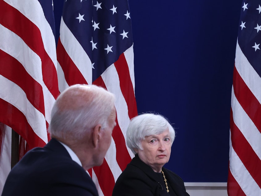 caption: U.S. Treasury Secretary Janet Yellen listens to President Biden discuss the federal debt limit on Oct. 6, 2021, in Washington, D.C.