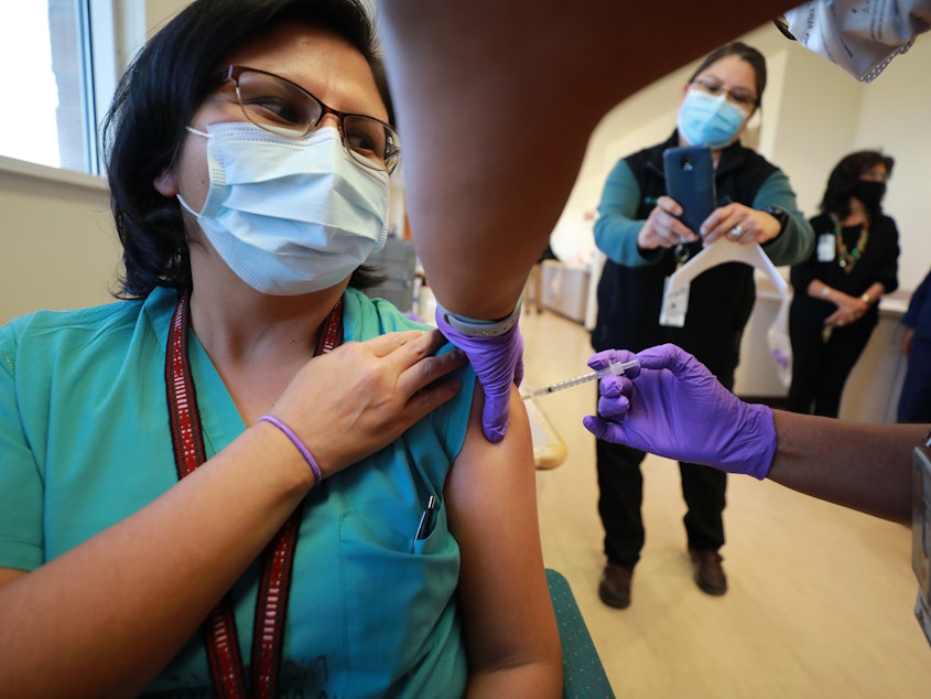 caption: Dr. Lawanda Jim, Chair of Internal Medicine, receives a COVID-19 vaccine at Northern Navajo Medical Center on Tuesday in Shiprock, N.M.