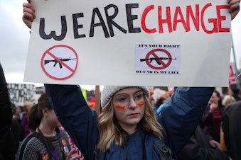 caption: Reilly Donham, 18, of Mill Creek, Washington, attends the 'March for Our Lives' rally in Seattle on Saturday morning.
