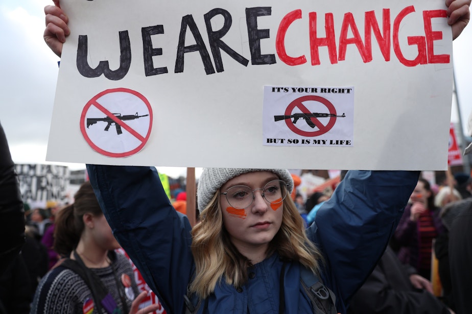 caption: Reilly Donham, 18, of Mill Creek, Washington, attends the 'March for Our Lives' rally in Seattle on Saturday morning.