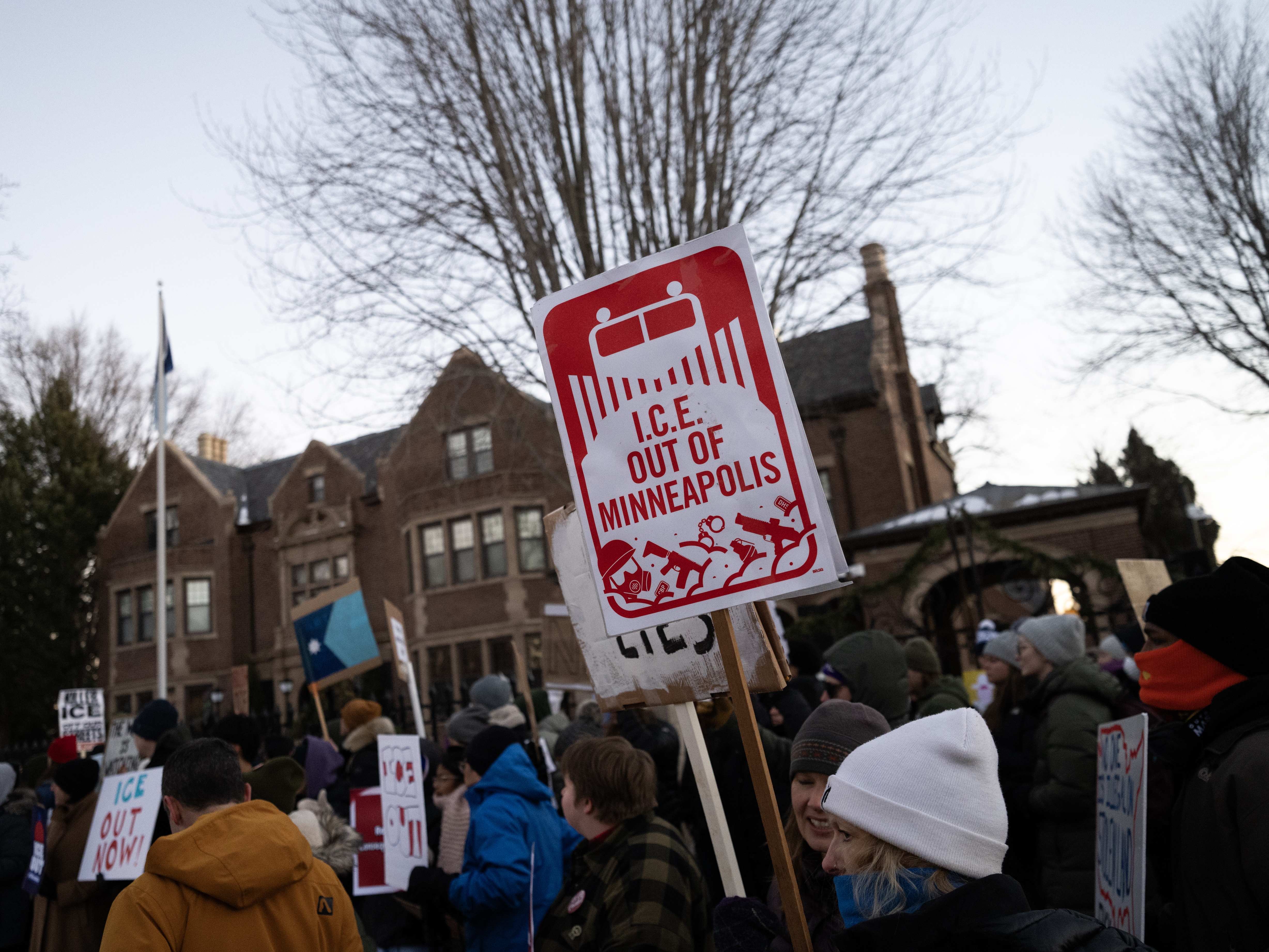 caption: People demonstrate against federal immigration enforcement outside the Minnesota governor's residence in St. Paul on Feb. 6.