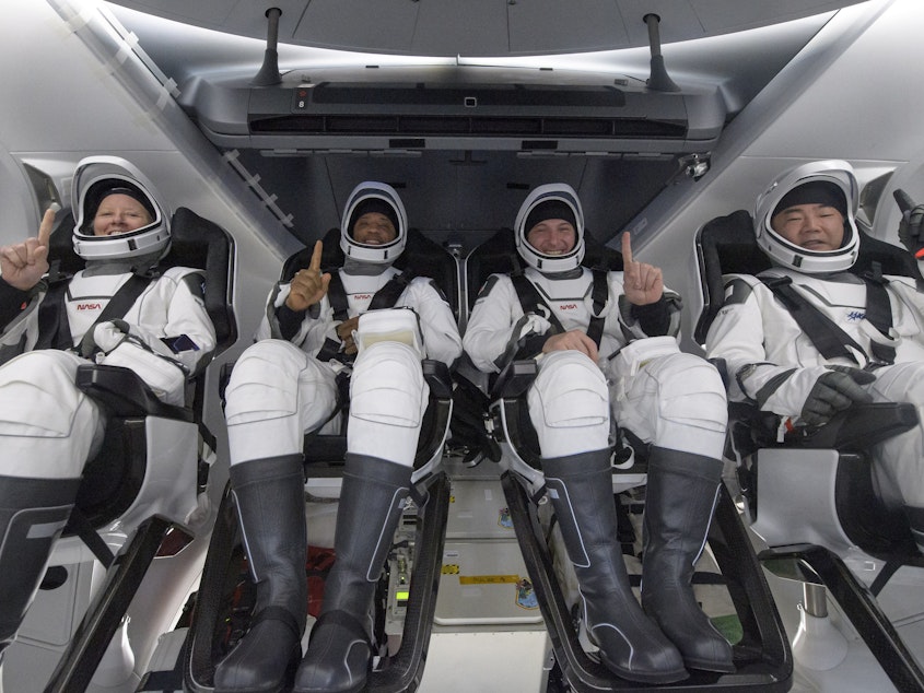 caption: NASA astronauts Shannon Walker (left), Victor Glover, and Mike Hopkins, along with Japan Aerospace Exploration Agency astronaut Soichi Noguchi, are seen inside the SpaceX Crew Dragon Resilience spacecraft onboard the SpaceX GO Navigator recovery ship shortly after landing in the Gulf of Mexico off the coast of Panama City, Fla., on Sunday.